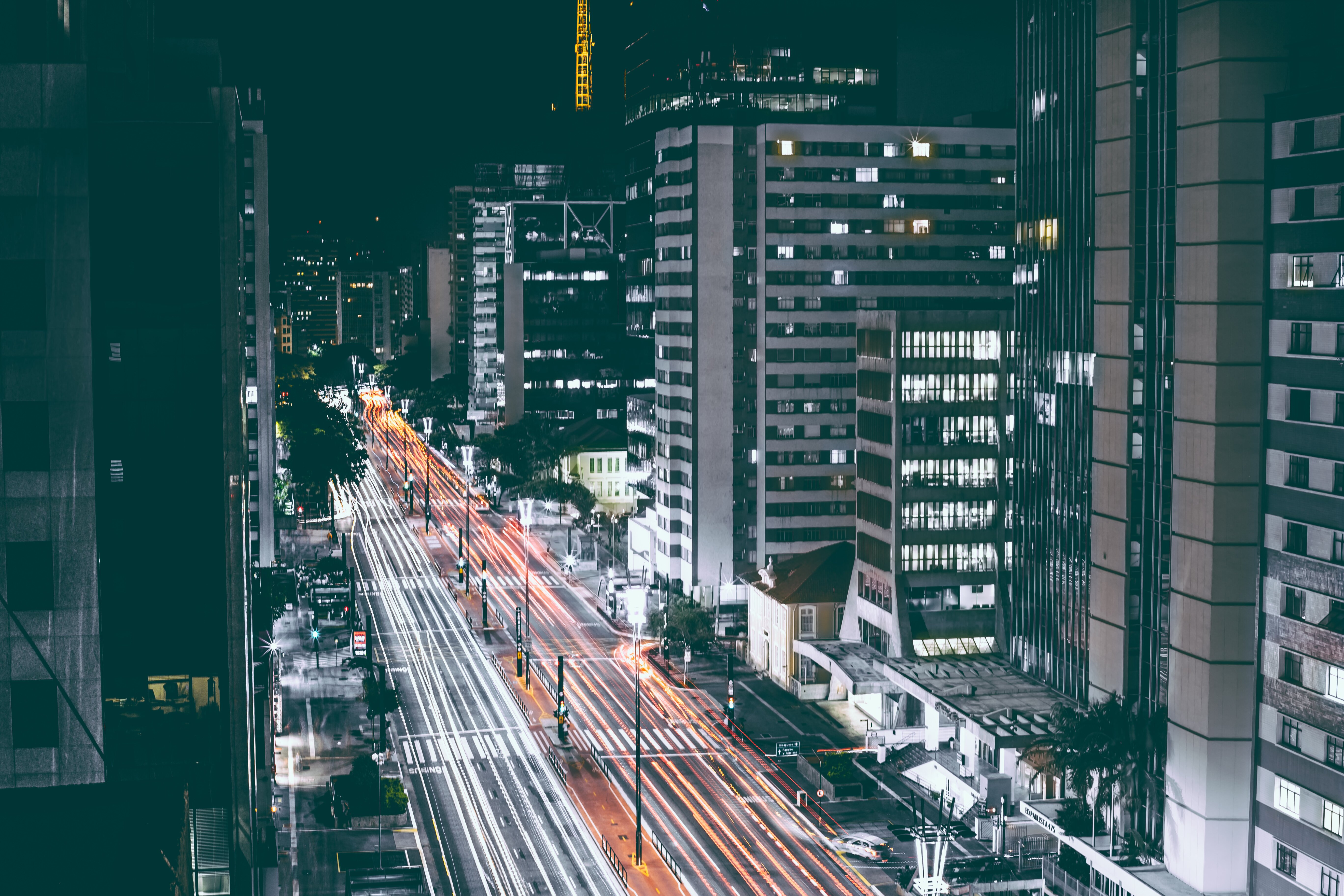 High Rise Buildings Beside Road during Nighttime Wallpaper photo