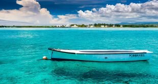 White boat on the blue clear water Wallpaper