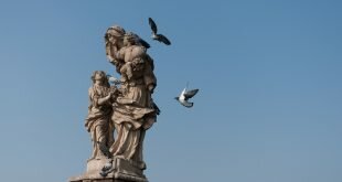 Woman Carrying Child Statue Wallpaper